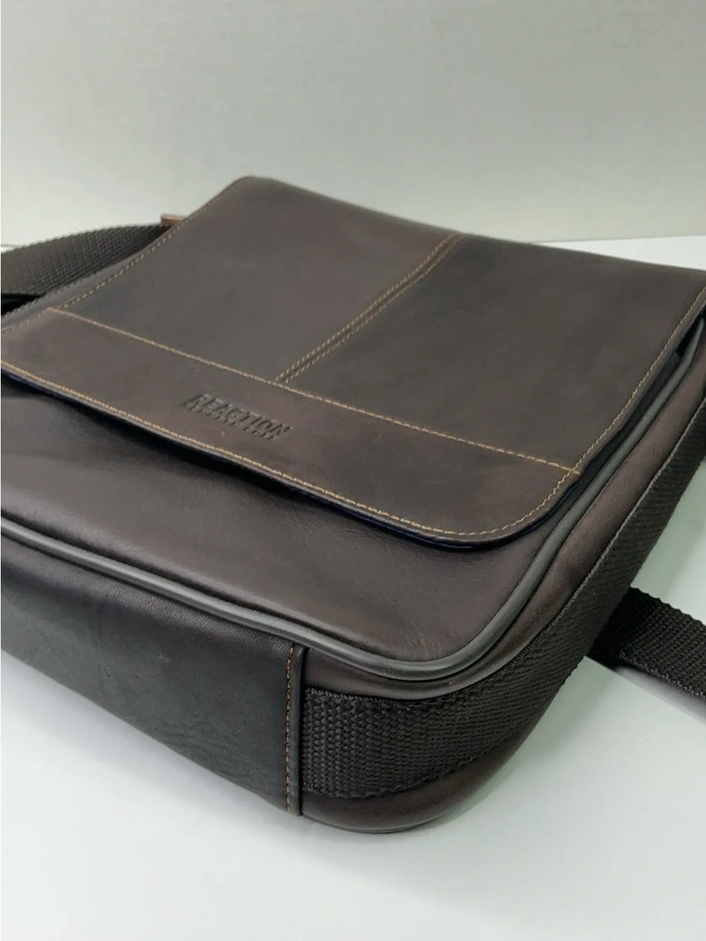 Kenneth Cole Reaction dark brown leather messenger-style tablet bag.